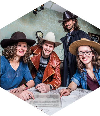Deciphering a clue at the table in The Saloon Escape Room